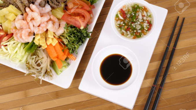 Asian vegetables with soy sauce and chopsticks